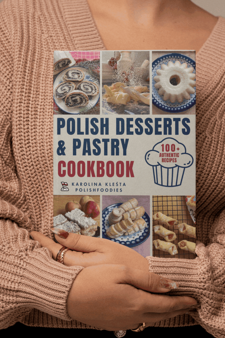 Person holding a Polish cookbook titled "Polish Desserts & Pastry Cookbook," featuring various Polish desserts on the cover and a label stating "100+ Authentic Recipes.