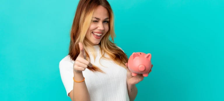 Frau mit Sparschwein und zuversichtlichem Lächeln hat ihre Finanzen im Griff – als Symbol für den Start in die finanzielle Sicherheit.