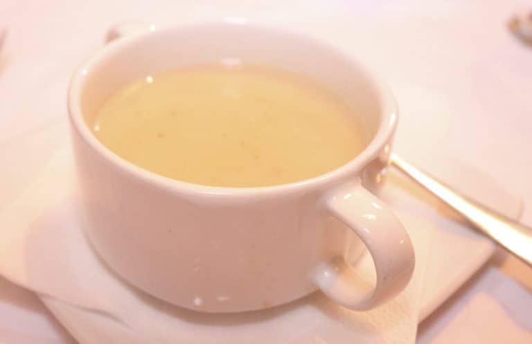 Soup Zalewajka in a white cup.