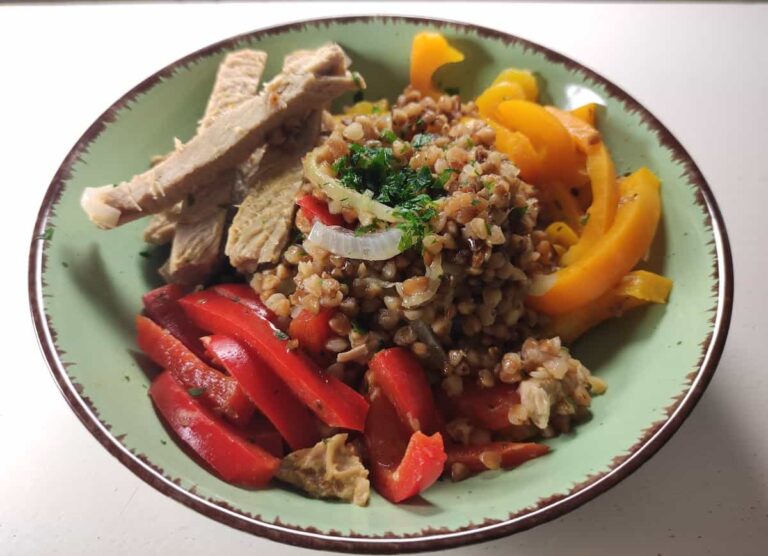 plate filled with buckwheat and chicken strips with veggies.