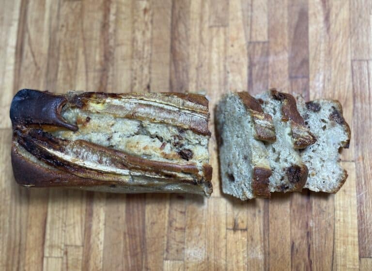 A slice of Polish banana cake on a wooden table.