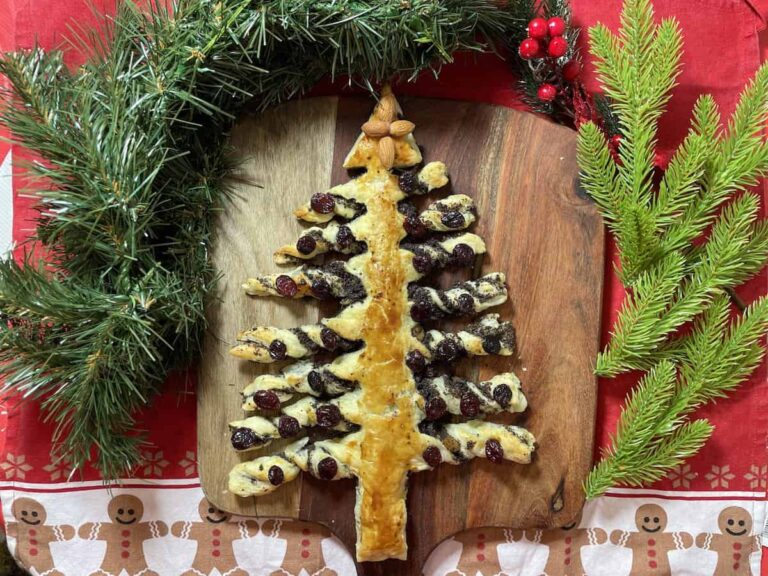 A Poppyseed Christmas tree cake on a cutting board.
