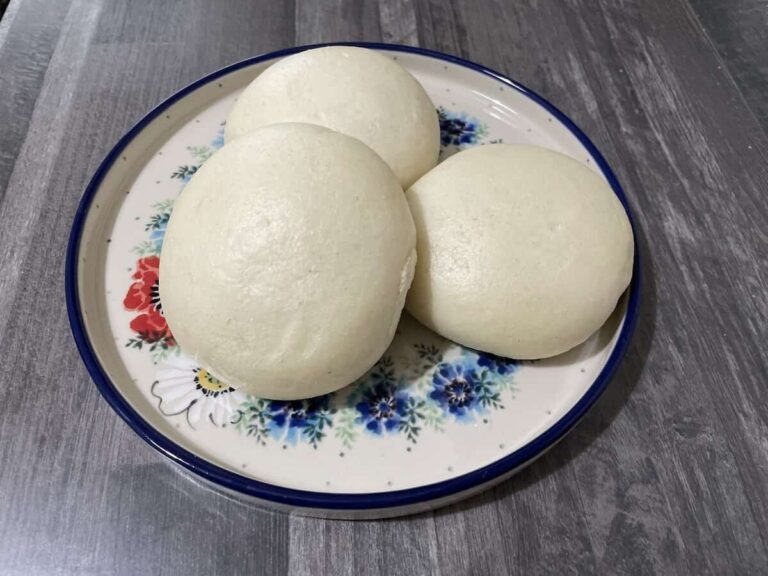 Three white Polish Steamed Buns on a floral plate.
