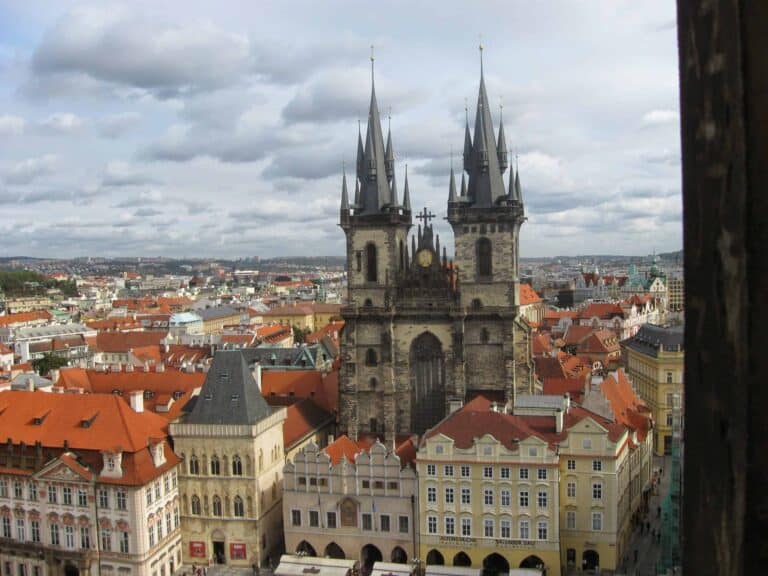 Aerial view of the Church of Our Lady before T&yacute;n with its twin spires, surrounded by red-roofed buildings in Prague's Old Town Square&mdash;an iconic sight for those seeking the best routes and travel options from Krakow to Prague.