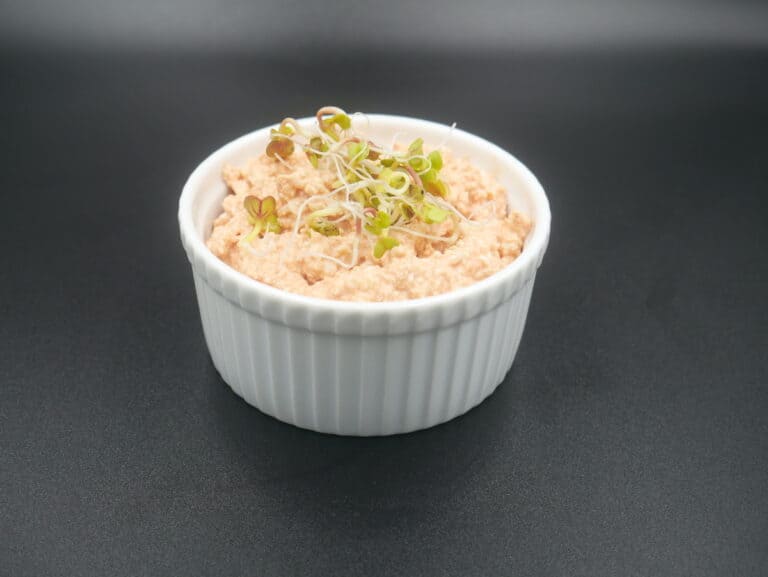 A bowl of Polish tuna salad with sprouts in it.