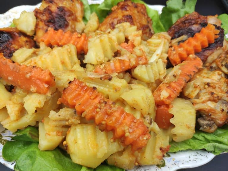 A plate of pasta salad with chicken.