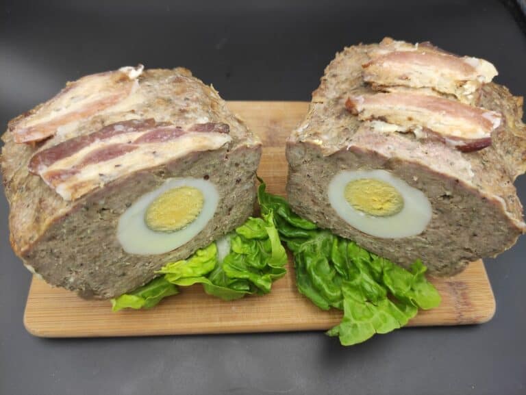 Two slices of meatloaf, a traditional Polish dish, on a cutting board.