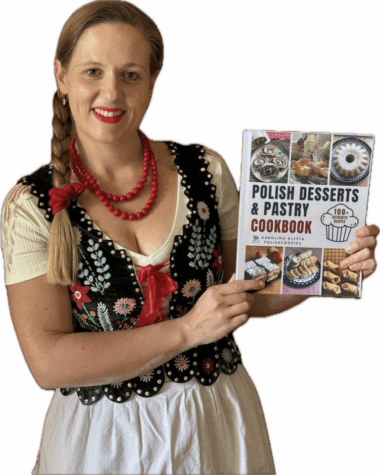Woman in traditional Polish attire holds a cookbook titled "Polish Desserts & Pastry Cookbook," featuring images of various pastries on the cover&mdash;a perfect find for Polish Foodies and fans of authentic Polish food.