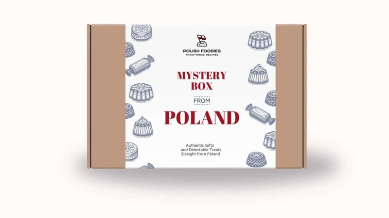 A cardboard box labeled "Polish Mystery Box" with the Polish foods logo, decorated with illustrations of traditional Polish hats.