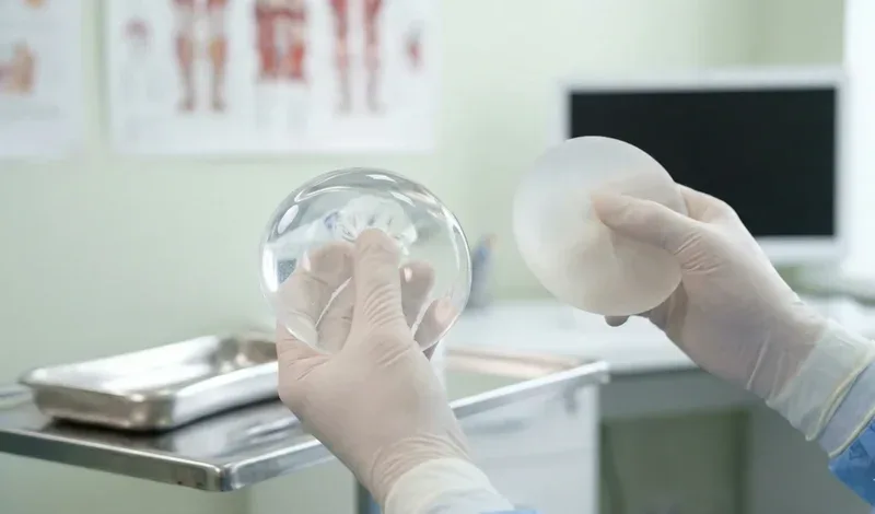 surgeon demonstrating texture difference silicone vs saline implants