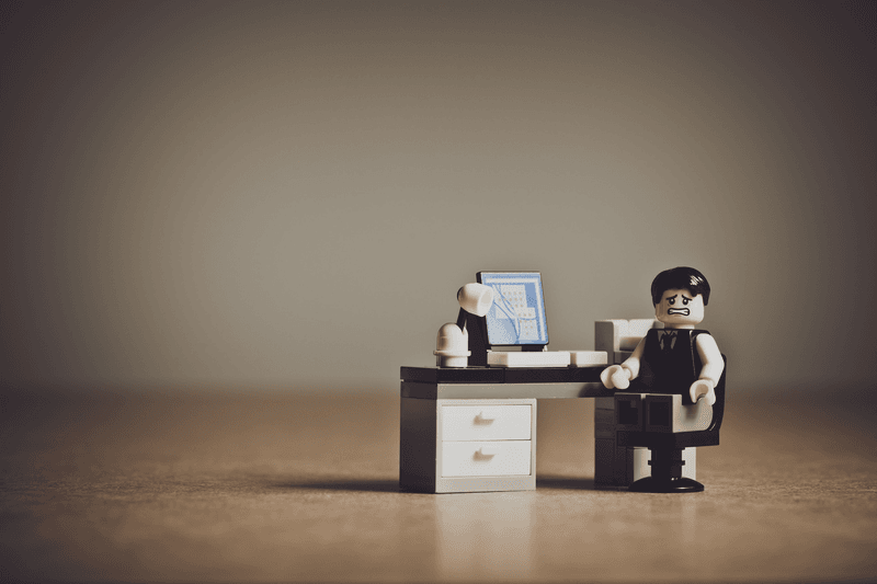 Lego-Mann am Schreibtisch als glücklicher Kunde