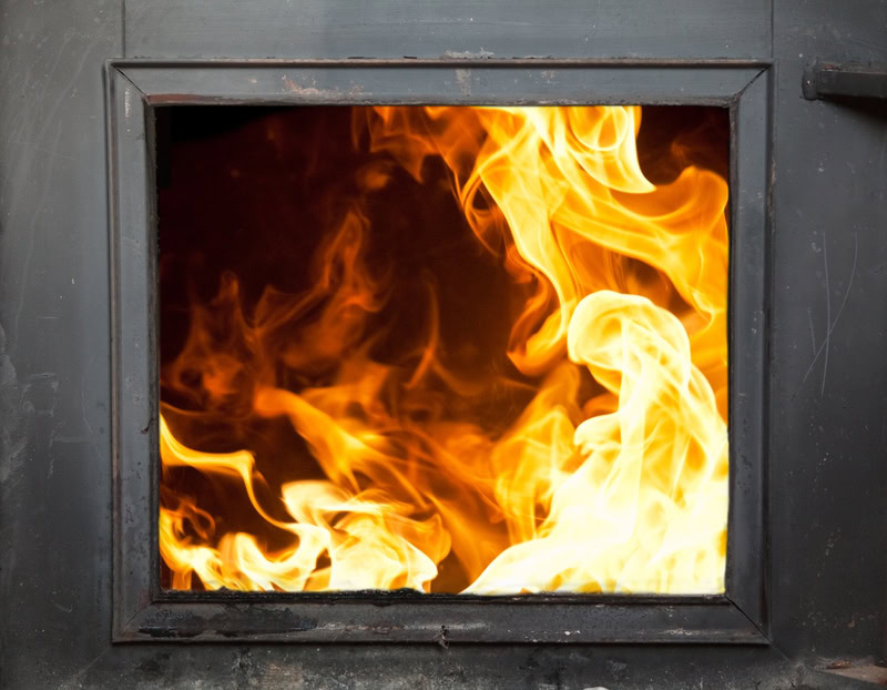 A metal structure of an incinerator with a window to see flames inside. Incinerators are one of the most common PFAS disposal methods.