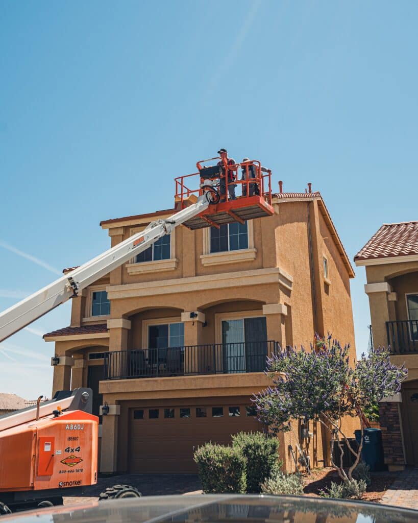 Sun Source installers preparing to install solar panels on a residential roof.