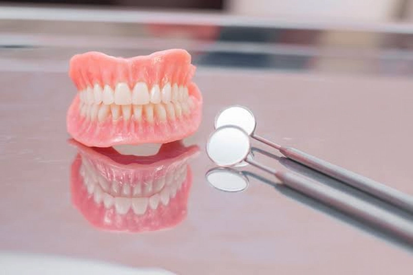 the hidden risks of using denture adhesive for a dental crown
