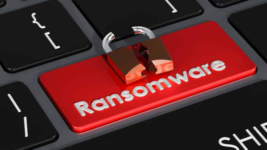 A keyboard with a red ransomware button