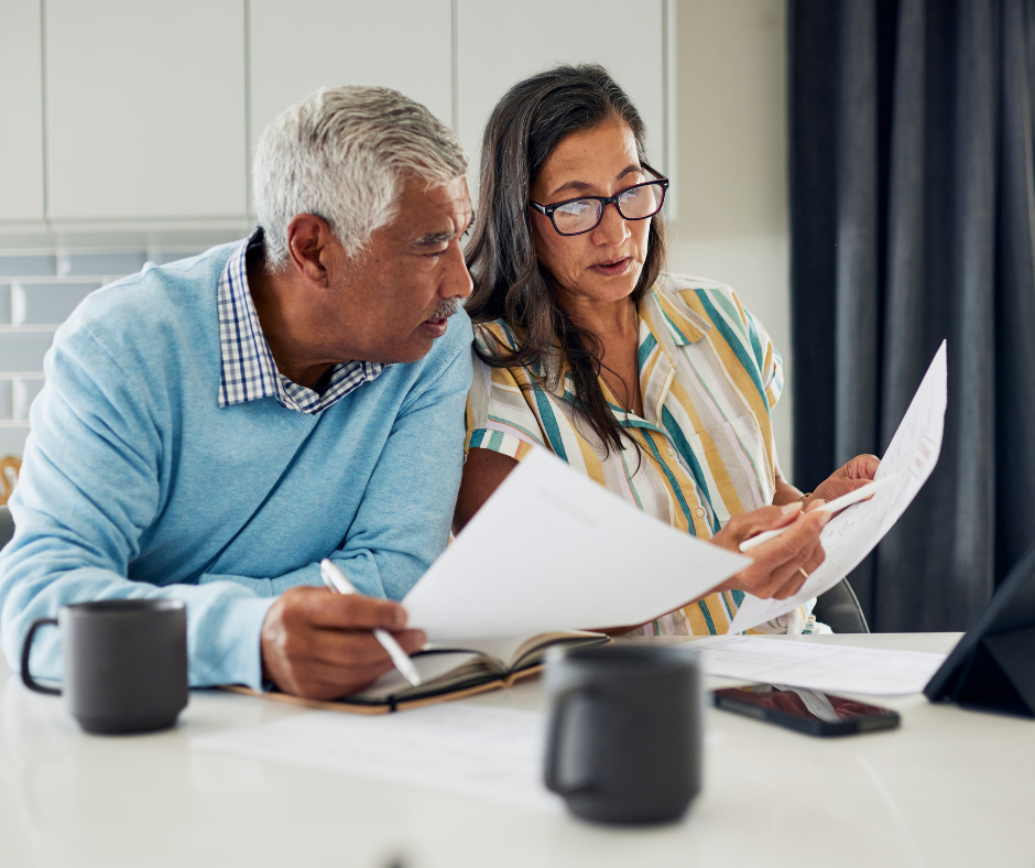 Older couple reviewing legal documents together at a kitchen table