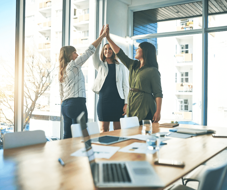 three women giving each other a high 5