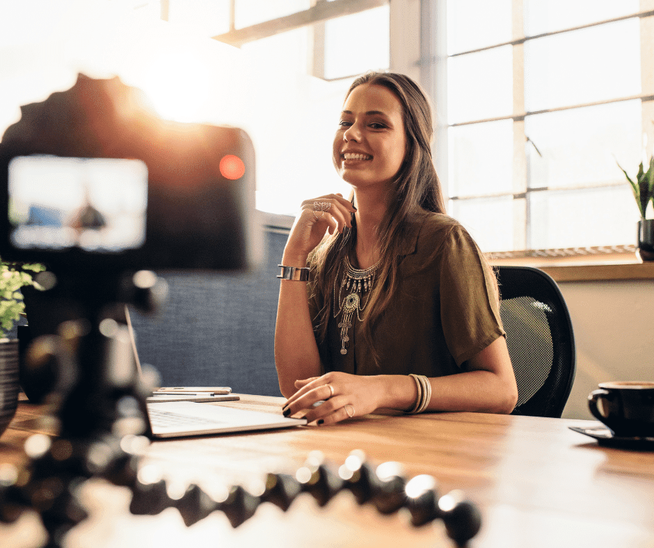 A smiling woman sitting at a desk
