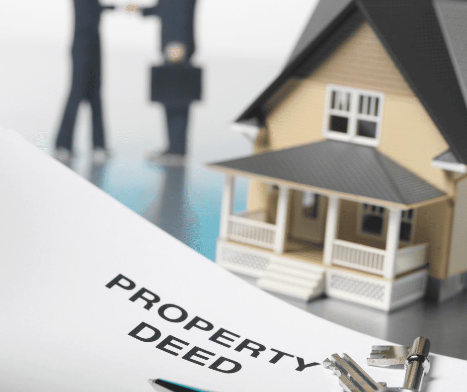 Picture of a toy house and document that says Property Deed.