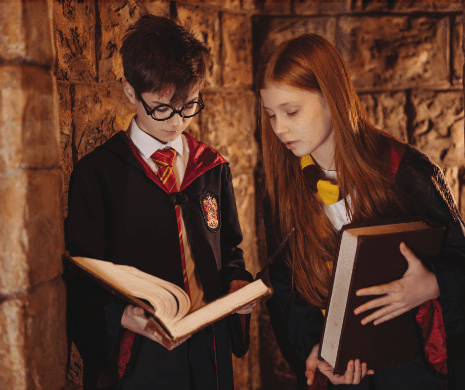 2 children dressed as judges looking at large law books.