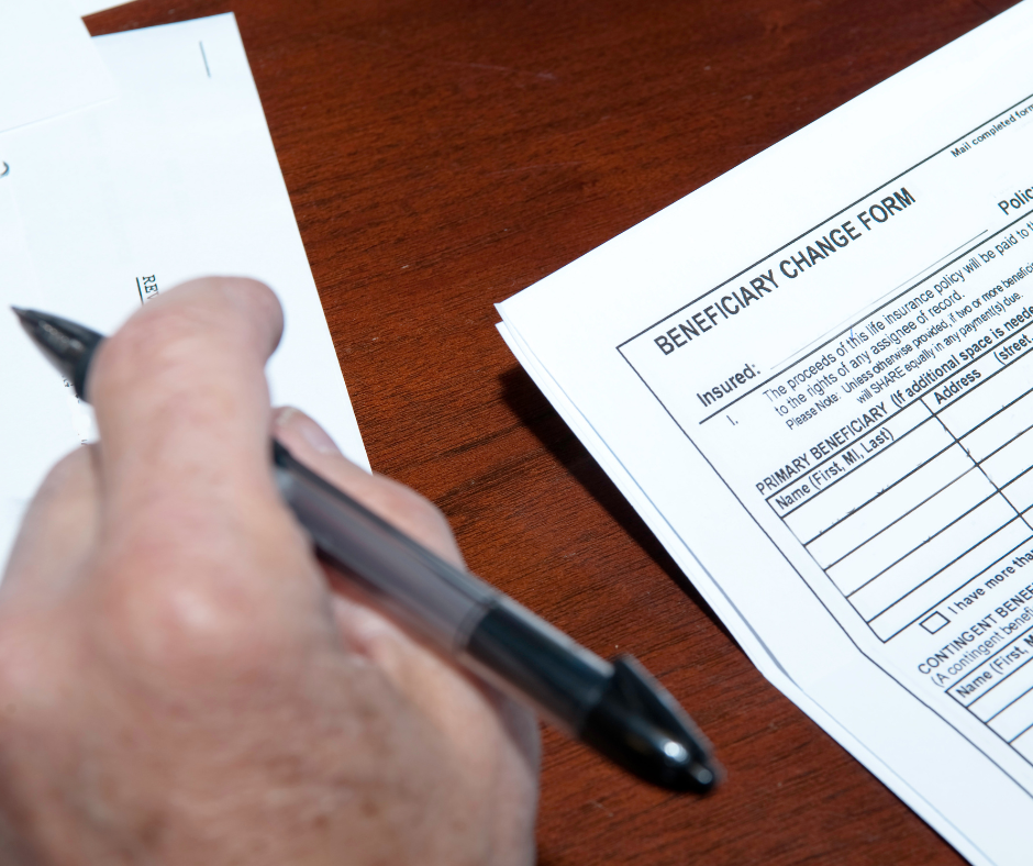 Person completing a beneficiary change form for a life insurance policy as part of Florida estate planning