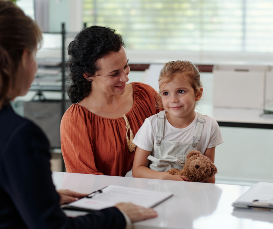 Mother and young daughter meeting with a Florida estate planning attorney to protect their child's inheritance