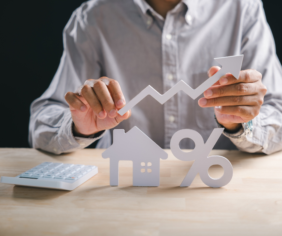 Hands holding a house icon, percentage sign, and rising arrow representing step-up in basis and property value growth