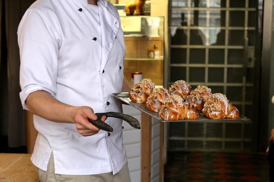 Chef presenting a tray of freshly baked Polish street food.