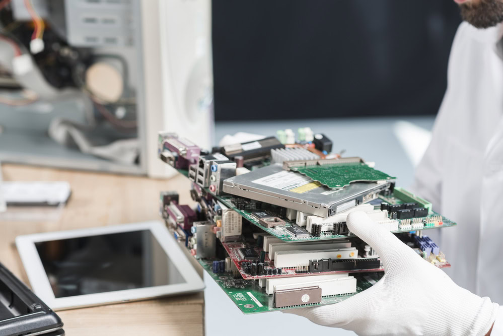 male-technician-hand-wearing-gloves-holding-computer-parts 