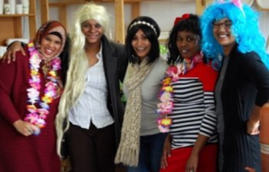 five women with big hair smiling 