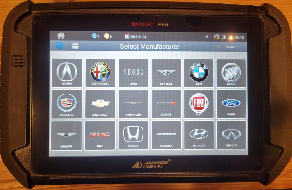 A Smart Pro automotive key programming tablet by Advanced Diagnostics displaying a 'Select Manufacturer' screen with various car brand logos, including Acura, BMW, Ford, Honda, and more.