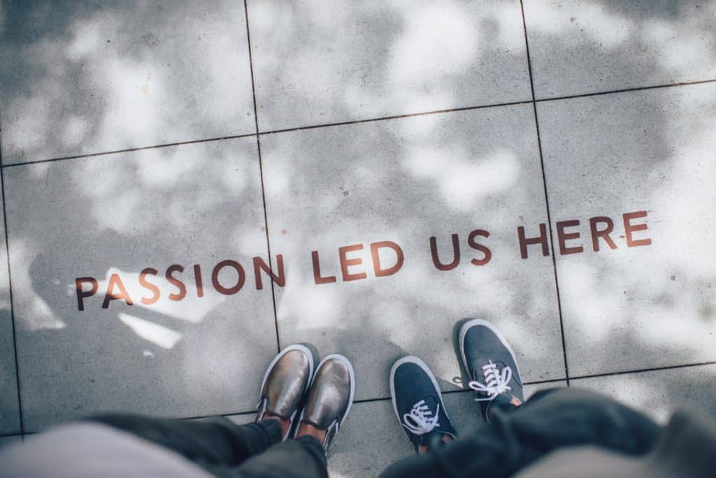 How do Entrepreneurs stay motivated? 6 a photo on a sentence on the ground "passion led us here"
