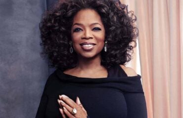 Oprah Winfrey Oprah Winfrey wearing a black dress with hands saying thank you