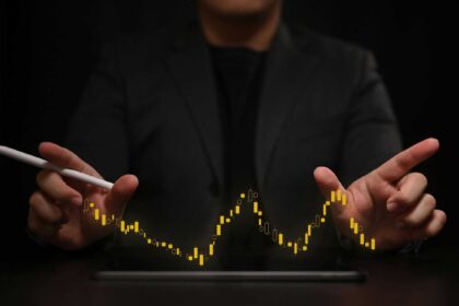 a person holding a stylus and a tablet