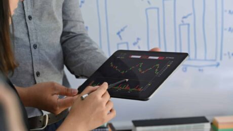 a person holding a tablet with a graph on it