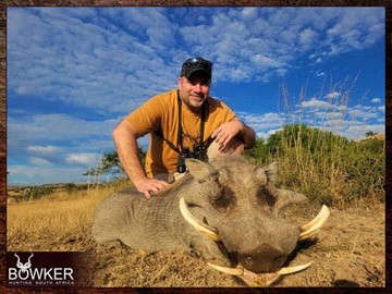 Plains Game Hunting in Africa - Hunt Plains Game with Nick Bowker 33 Client with a warthog a typical plains animal.