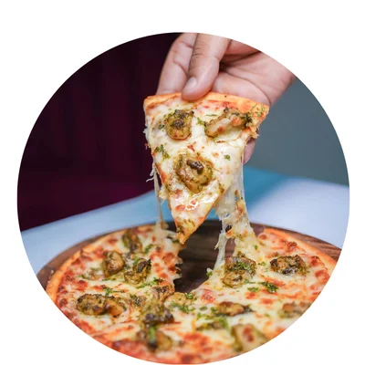 a hand holding a slice of pizza