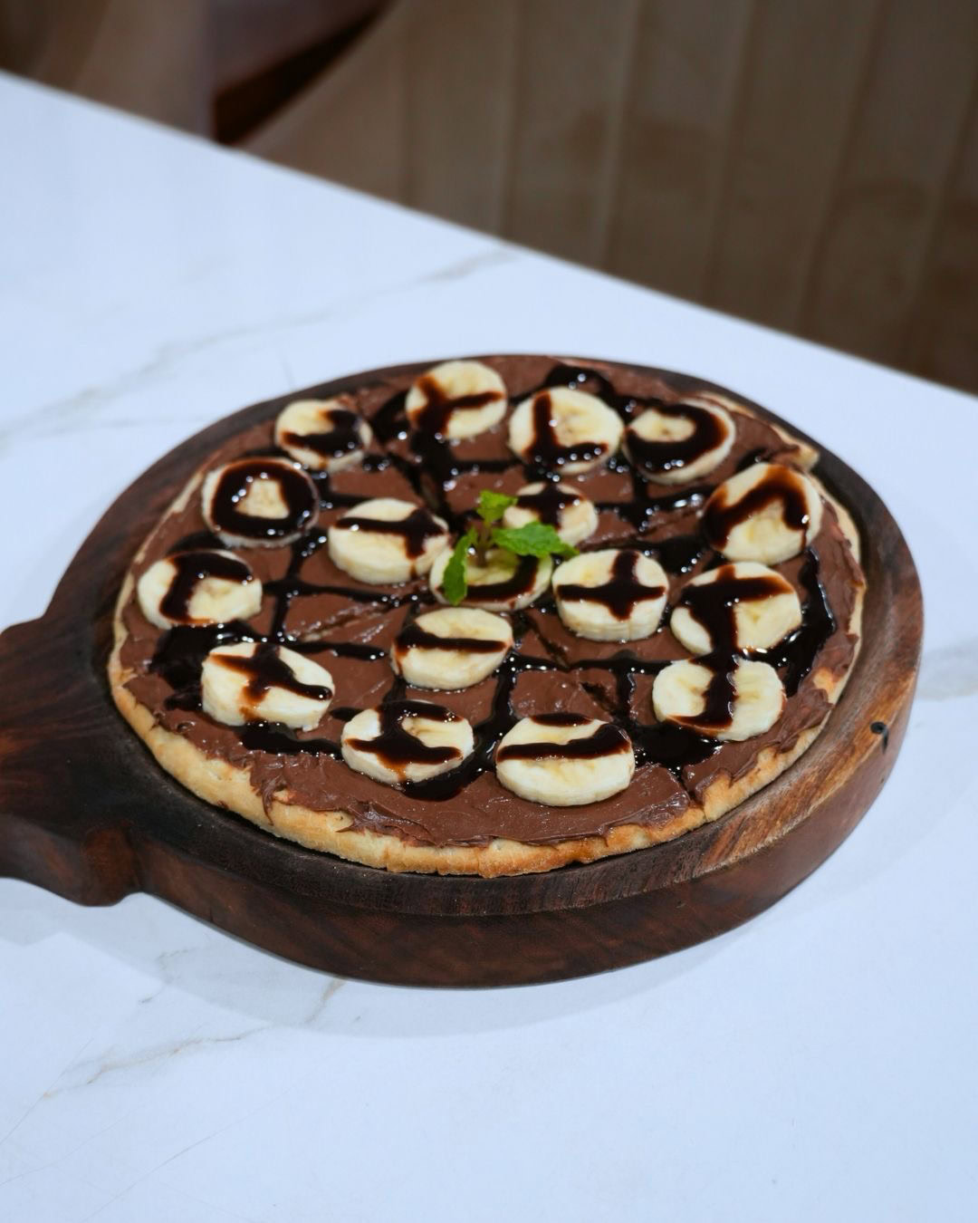 Pizza topped with banana and Nutella
