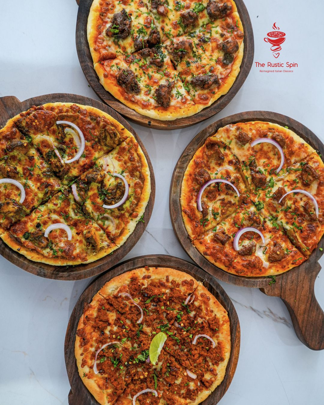Four delicious pizzas on wooden boards