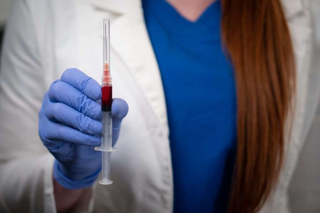 Doctor holds a B12 and B-Complex injection