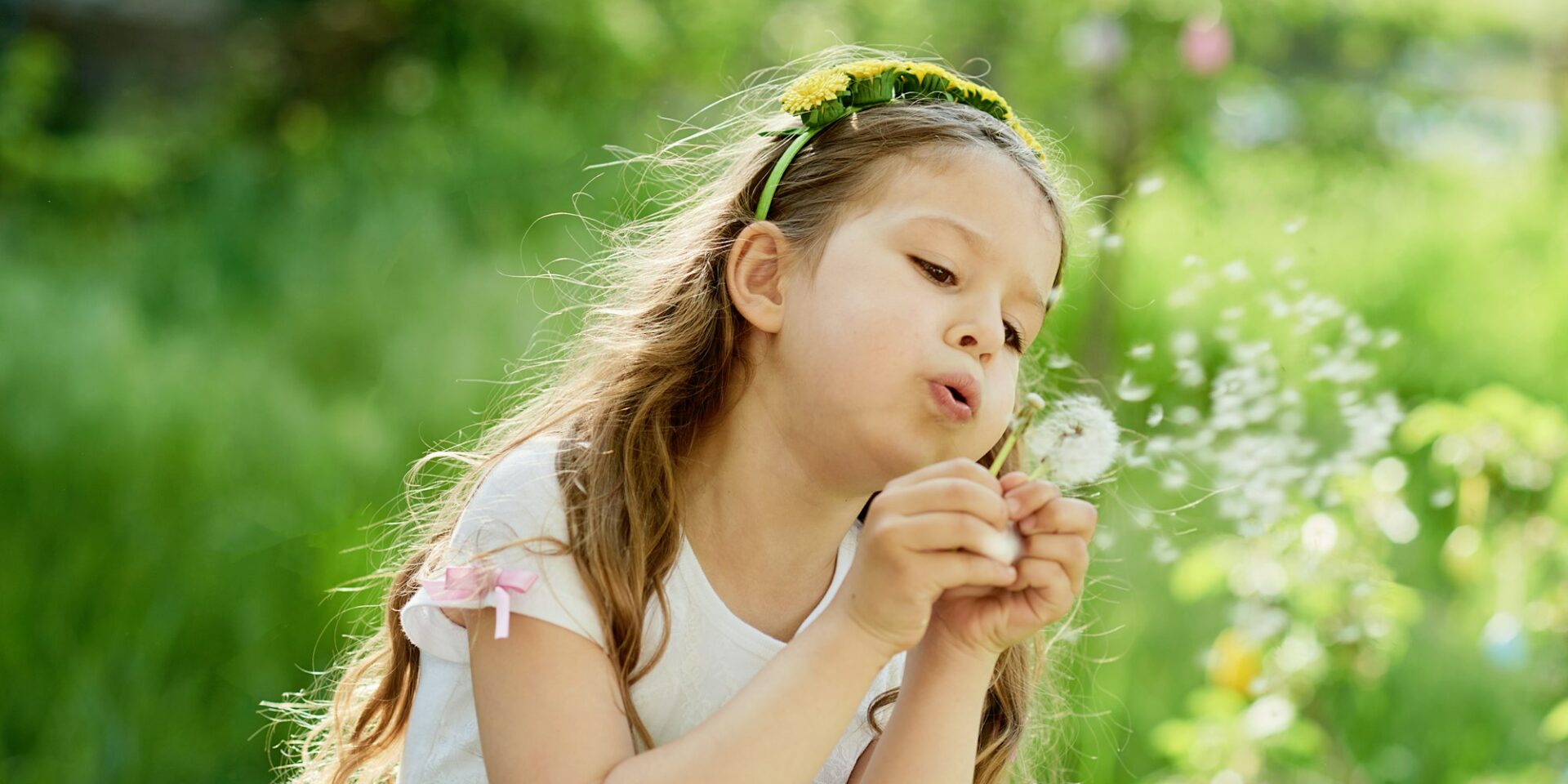 girl blowing dandelions in Meridian Boise, ID during allergy season
