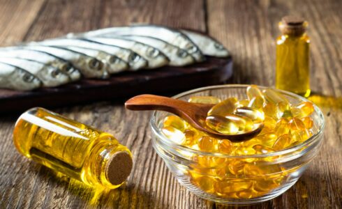 Fish oil capsules on wooden background as prescribed by functional medicine doctor in Meridian, ID