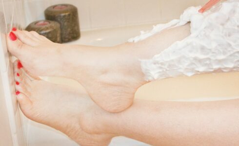 A woman shaves her legs after laser hair removal to reduce Folliculitis in Meridian Idaho