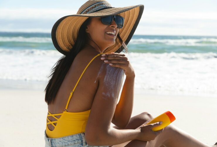 Smiling woman on beach using sunscreen to maximize vitamin D in Boise Idaho