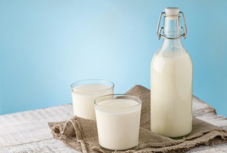 Bottle and glass with milk for lactose problems in functional medicine