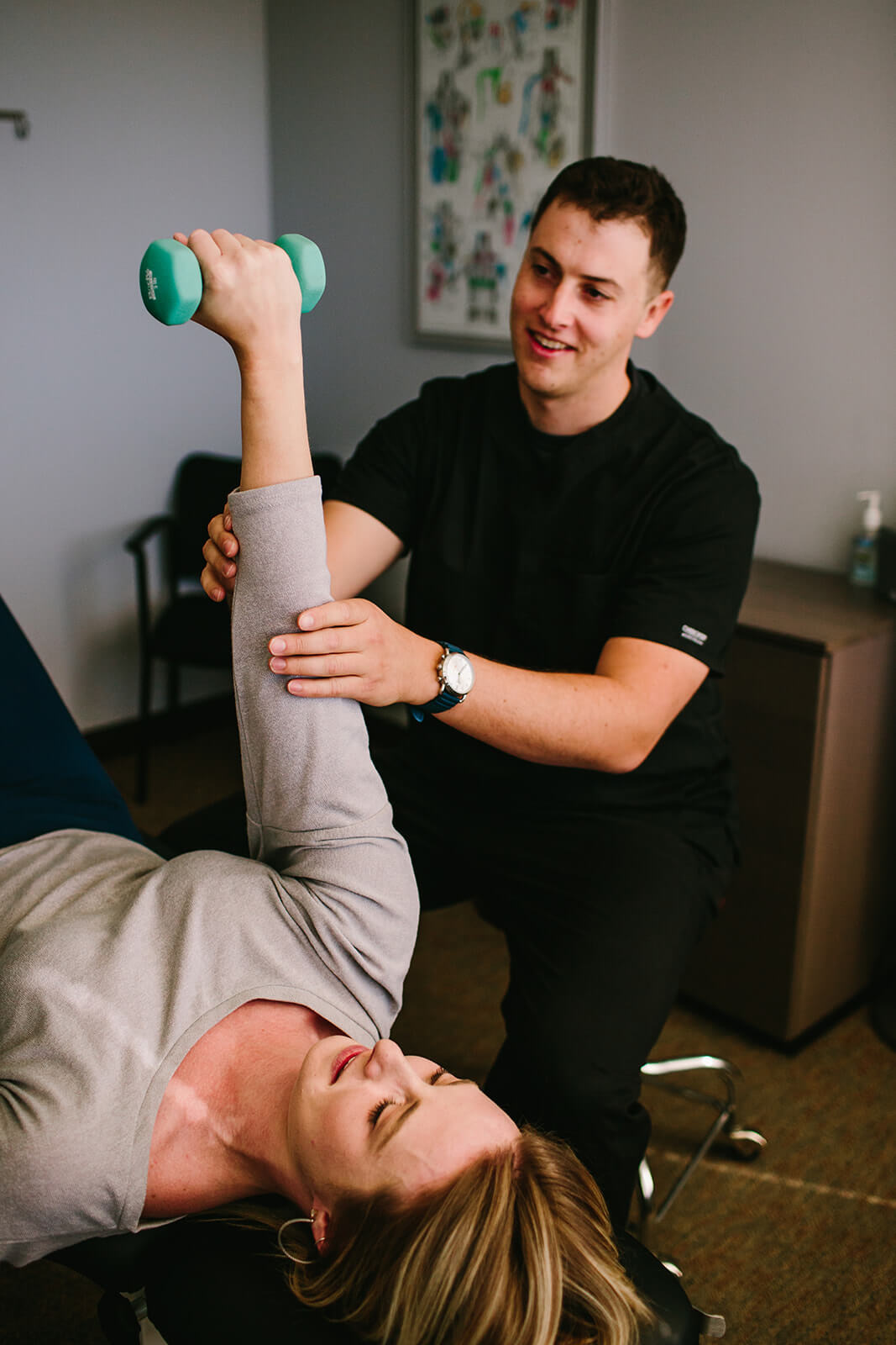 professional physical therapist performing physical therapy exercises with woman