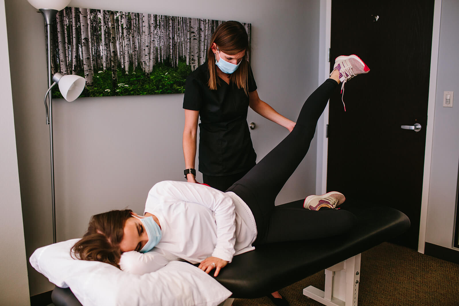 Physical therapy guiding patient through exercise