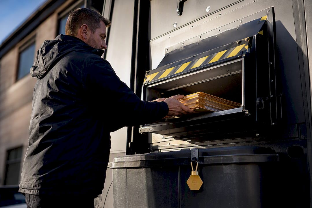 1789209856074_Operator-feeding-documents-into-mobile-shredder Operator feeding documents into mobile shredder