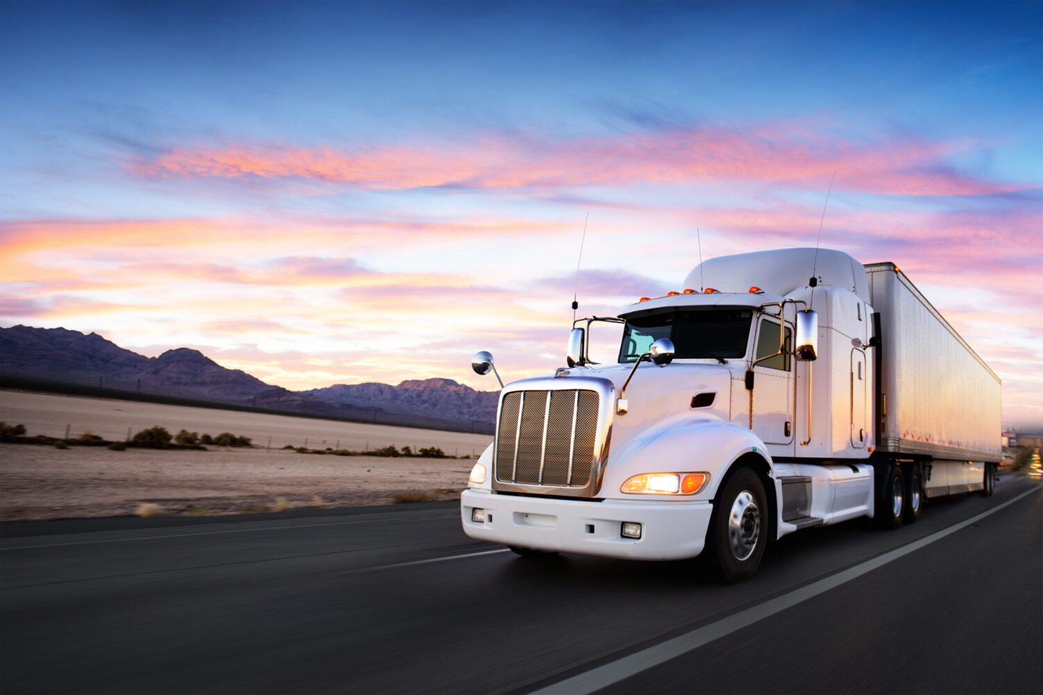 Truck and highway at sunset - transportation background Project Trucking - Heavy haul - over dimensional trucking - project trucking