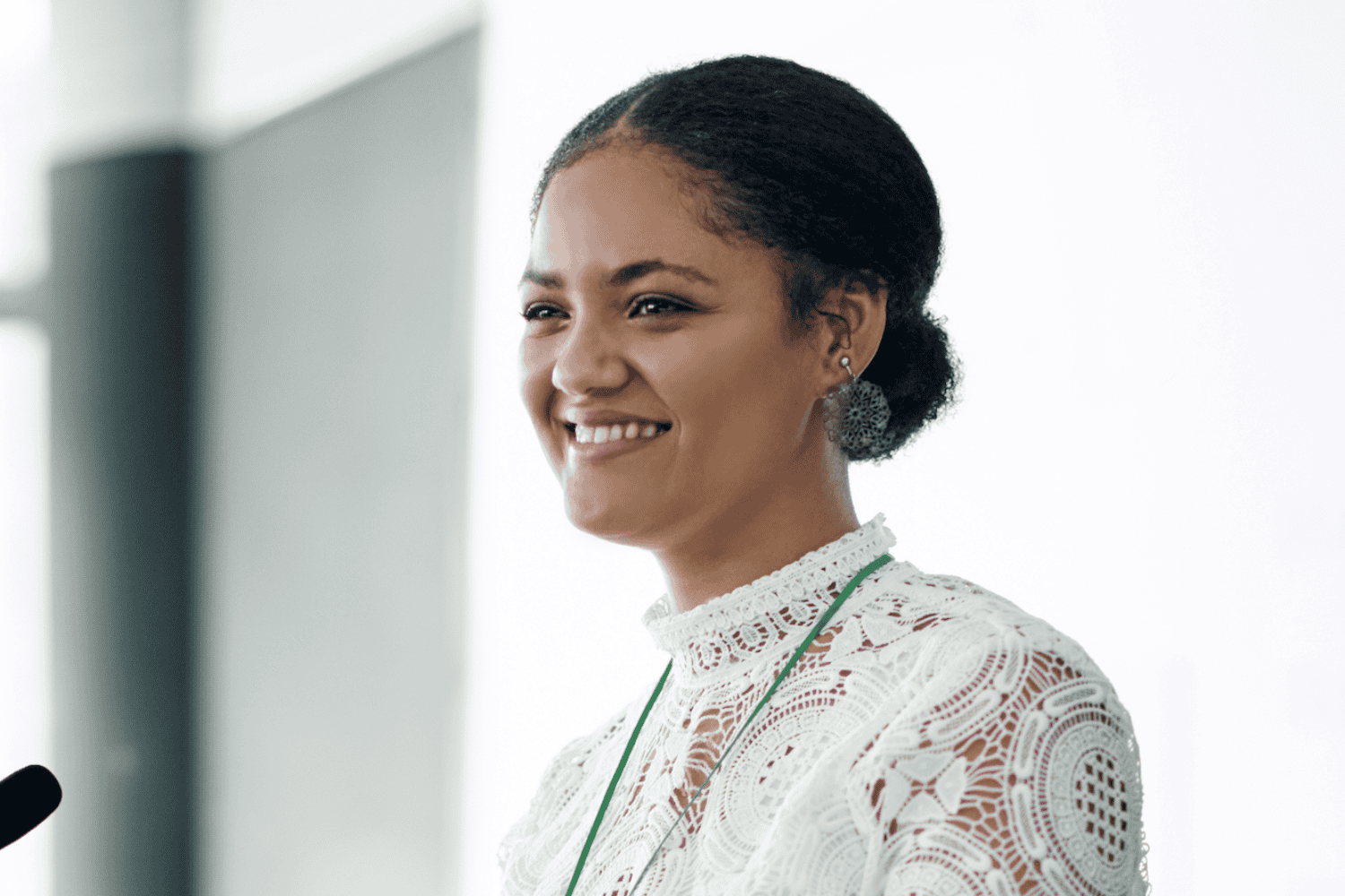 Young confident woman presenting speech at mic